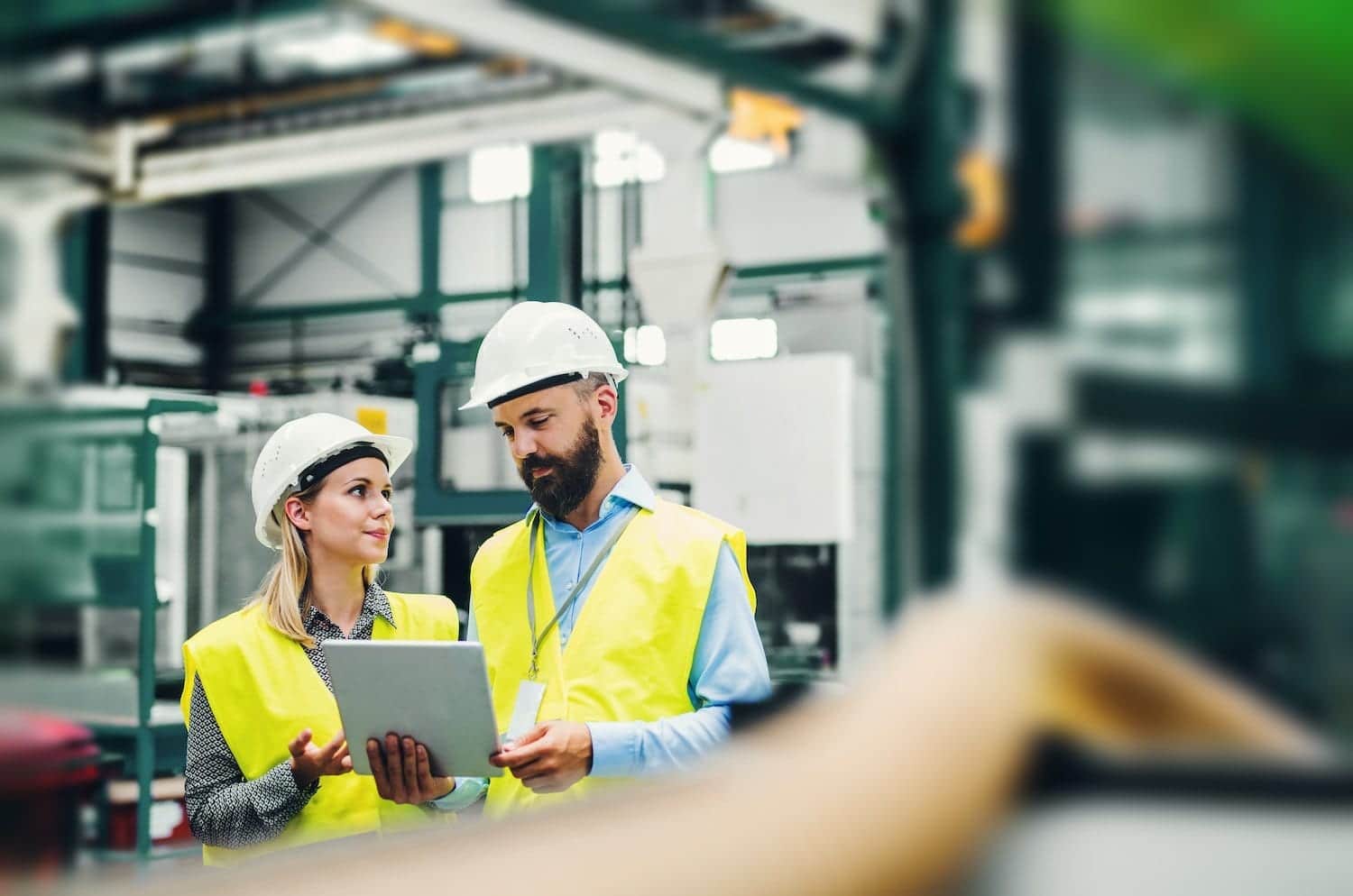 factory workers looking at a tablet