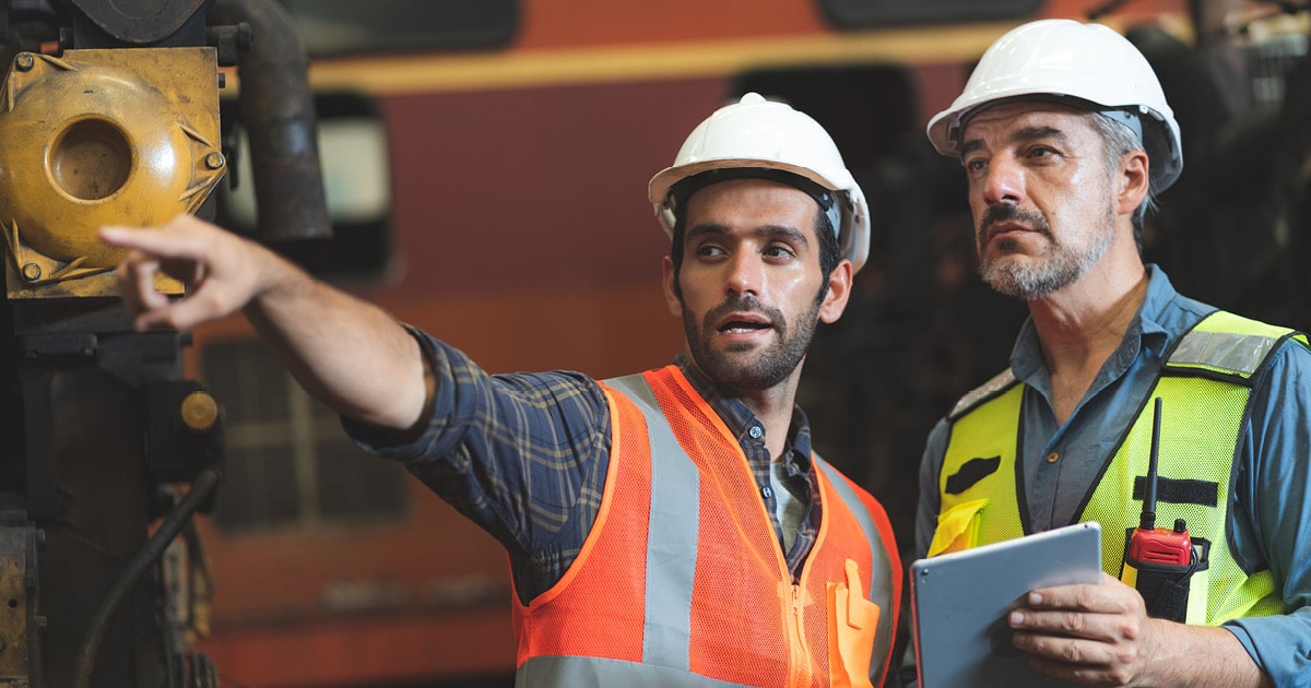 Two factory managers inspecting operations for manufacturing compliance