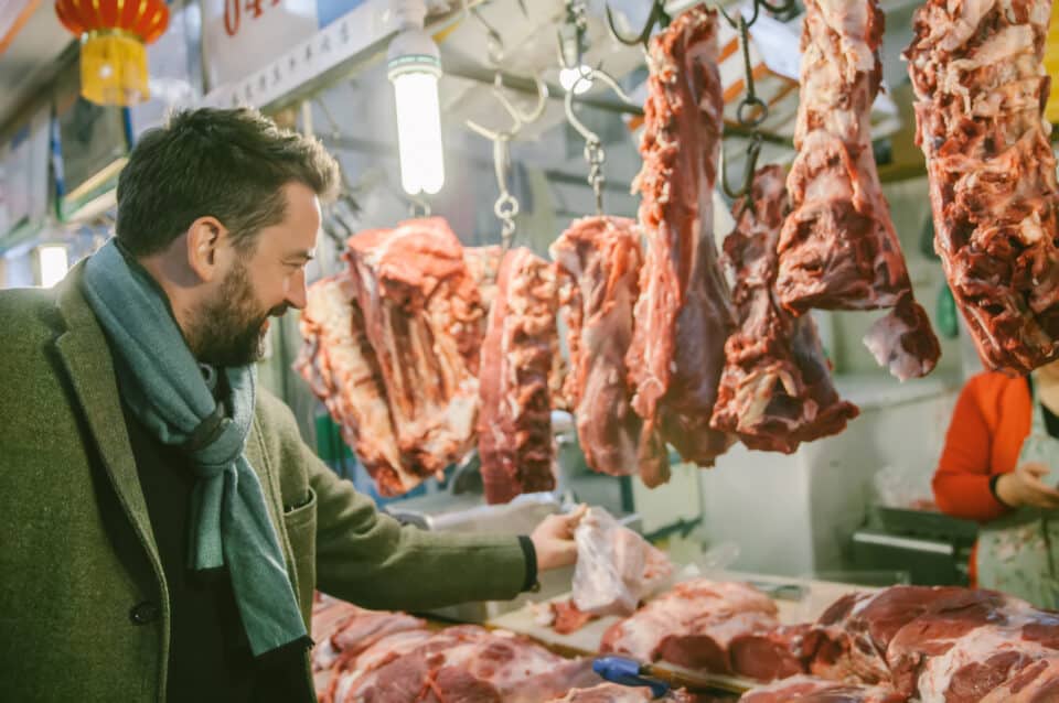 Man at Market Buying Meat