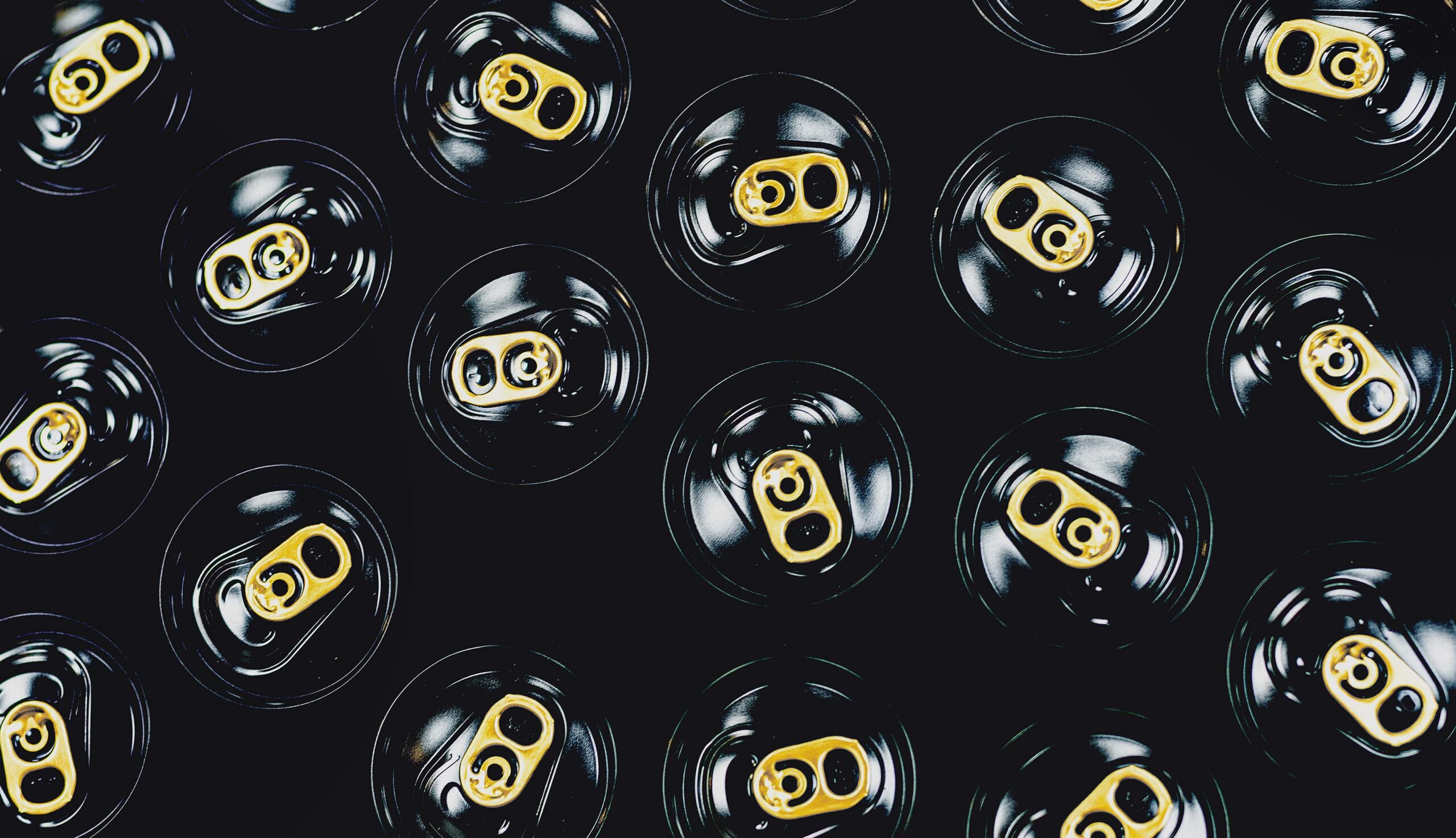 Overhead view of black cans with gold tabs
