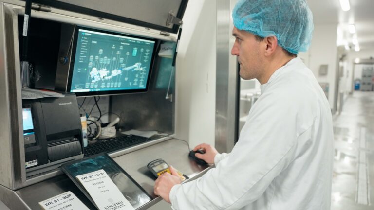 Worker at computer wearing hair net